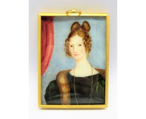 19th century miniature half length portrait of a young lady, in a green dress with fur stole and her hair in an Apollo knot, 