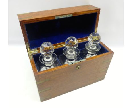 Early 20th century oak and brass bound decanter box by Army &amp; Navy, containing three faceted glass decanters, L35cm x H28