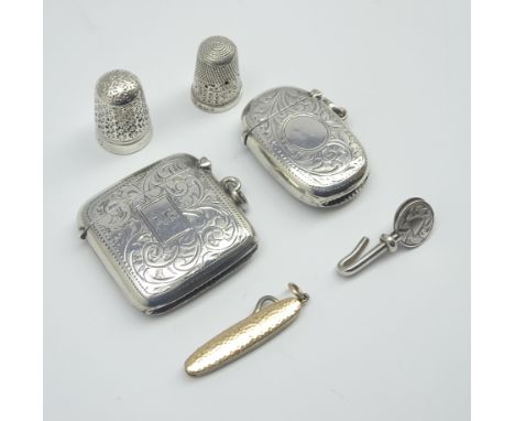 Miniature button hook in gold case marked '9ct' , 2 silver vesta cases, serviette clip and 2 thimbles