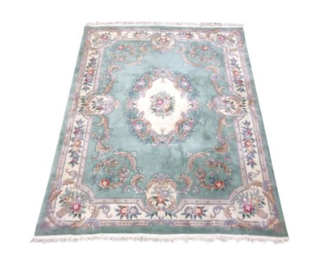 Large Chinese washed woollen rug carpet, pale mint ground, decorated with flowers and scrolls, 370cm x 272cm