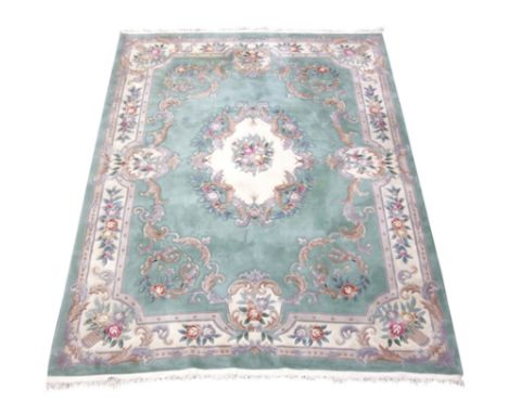 Large Chinese washed woollen rug carpet, pale mint ground, decorated with flowers and scrolls, 370cm x 272cm