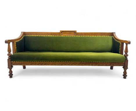 Late Victorian walnut framed sofa, rectangular backrest with carved detailing and central motif, upholstered in olive green f