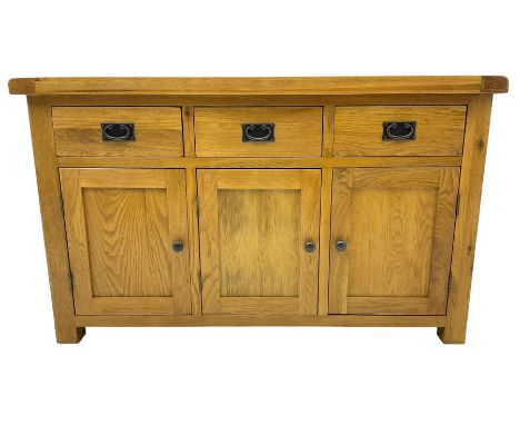 Contemporary light oak sideboard, fitted with three drawers over three panelled cupboards enclosing shelving, on square suppo