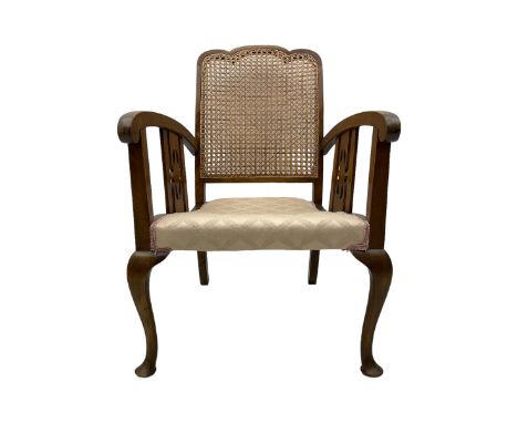 Early 20th century beech framed chair, with scalloped caned backrest, curved arms with pierced splats, upholstered seat in li