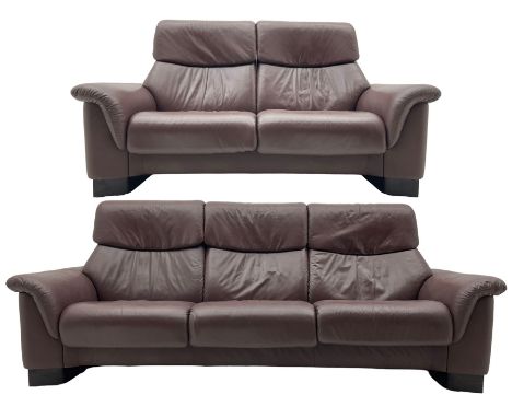 Ekornes Stressless - three-seat sofa upholstered in chocolate brown leather, with high backrests, cushioned headrests, and ma