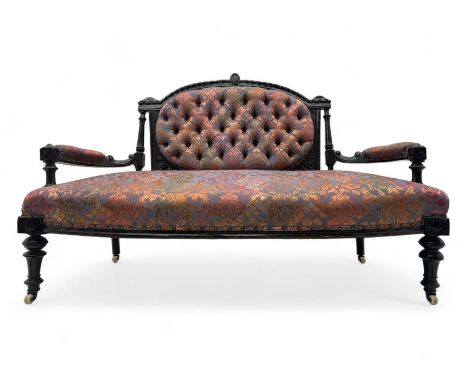 Late Victorian ebonised oak sofa, upholstered in muted purple fabric with iridescent floral pattern and nailhead trim, button