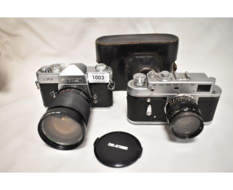 Two cameras. A Fujica ST701 with Sunactinon Auto zoom f28-80mm 1:3,5-4,5 lens, and a Zorki -4 camera with a Jupiter -8 lens