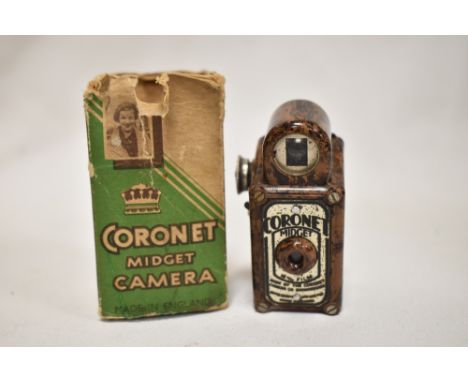 A Coronet Midget camera in brown marble bakelite with original box