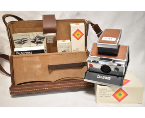 A Polaroid SX 70 Land camera with lens shade, accessory holder, remote shutter button in original leather case