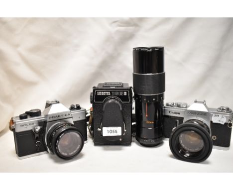 A selection of cameras. A Canon Pellix with a Canon FL 50mm 1:1;8 lens, a Praktica MLT50 with Pentagon auto zoom 1,8/50 lens,