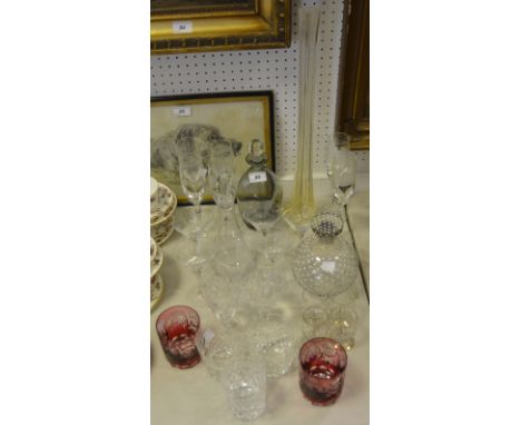 Glassware - a pair of cranberry glass acid etched tumblers; a smokey grey glass decanter; a clear glass globular decanter and