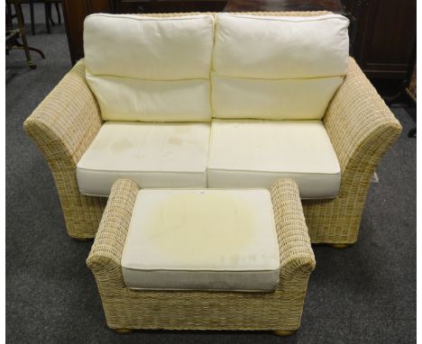 A contemporary wickerwork two seat conservatory sofa; conforming scroll armed stool with storage. (2)