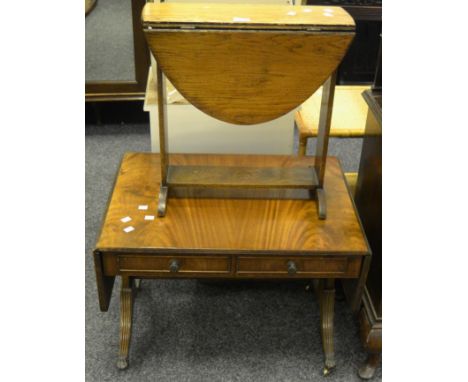 A Regency reproduction sofa table, drop ends, two short drawers to frieze, drum handles, reeded sabre supports, brass casters