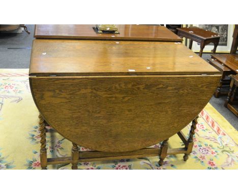 A mid 20th century oak gate leg dropleaf dining table, barley twist support, turned feet 122.5cm length x 81.5cm height (1)