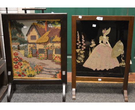 An early 20th century oak framed firescreen; another woolwork firescreen. (2)