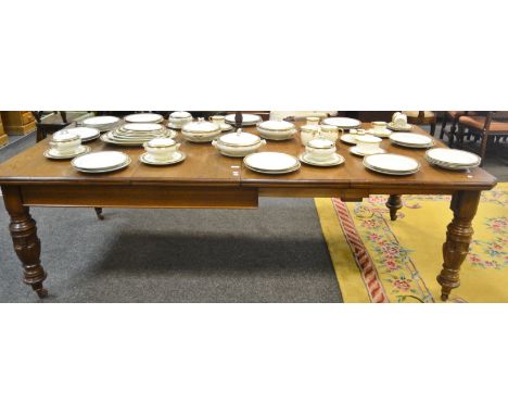 A Victorian wind out dining table, canted top, turned supports, ceramic casters, two leaves. 73.5cm high x 122cm wide x 143cm