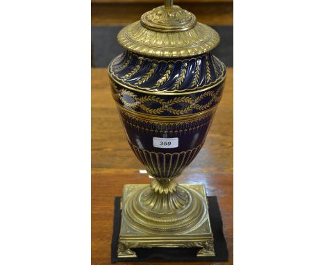 A decorative gilt-metal mounted cobalt blue urnular lamp.