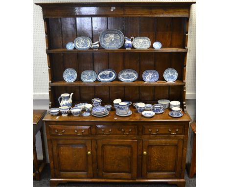 An oak Welsh dresser made by R. Norton, stepped cornice above two shelves, projecting base with three short fielded drawers, 