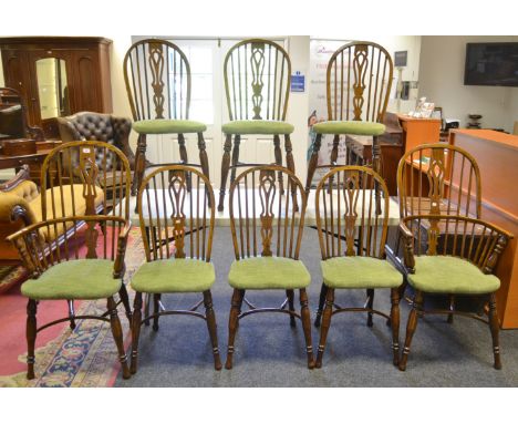 A set of six conforming oak stick back Windsor dining chairs, crinoline stretcher, turned supports, with two bow back carvers