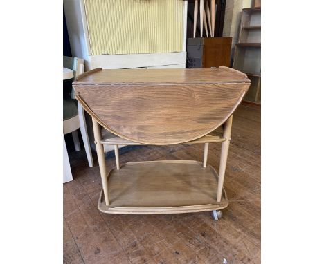 An Ercol light elm three tier trolley, 70 cm wide, lacks a wheel 