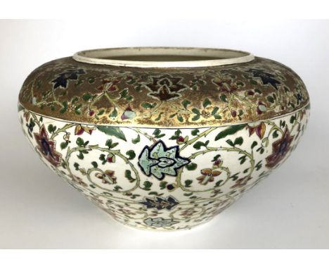 A Zsolnay Pecs style jardiniere decorated flowers, highlighted in gilt, 40 cm diameterSome cracks and some losses 