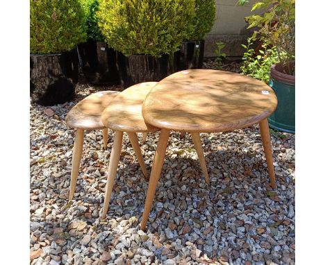 A nest of three Ercol light elm Pebble tables, 65 cm wide 