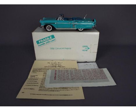 Danbury Mint - A boxed Danbury Mint 1:24 scale 1958 Chevrolet Impala. The model in turquoise appears to be in Mint condition 