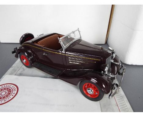 Danbury Mint - A boxed Danbury Mint 1:24 scale 1935 Chevrolet Standard Sports Roadster. The model in brown appears to be in M