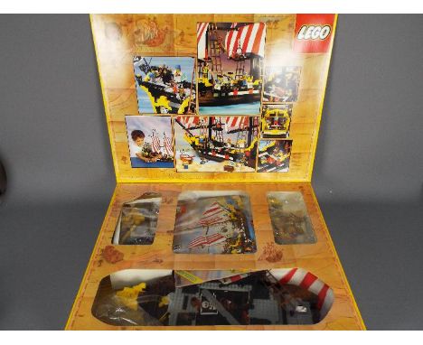 Lego - A boxed Legoland Pirate Ship # 6285. The set is part built and unchecked for completeness but appears in Good clean co