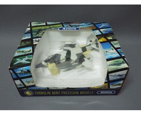 Franklin Mint - A boxed Franklin Mint 'Armour Collection' 1:48 scale B11E764 AV8 Harrier GR3 (RAF). The model appears in Mint