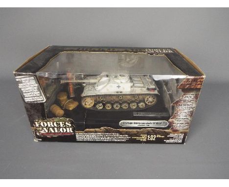 Forces of Valor - A boxed 1:32 scale Forces of Valor #81000 German Sturmgeshutz III Ausf.G (Ardennes 1944). The model appears