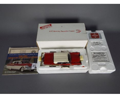 Danbury Mint - A boxed Danbury Mint 1:24 scale 1957 Mercury  Turnpike Cruiser. The model in red and white appears to be in Mi