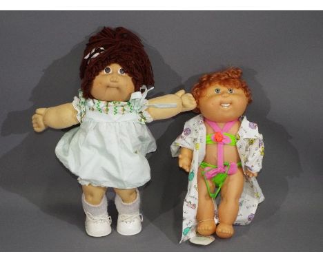 Hasbro - Two unboxed vintage Cabbage Patch Dolls. Lot includes a soft doll 'Lulu' with label stitched to side; together with 