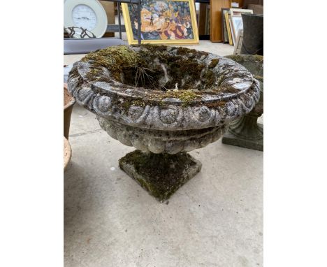 A LARGE RECONSTITUTED STONE URN PLANTER 