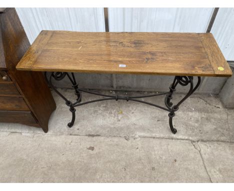 A 20TH CENTURY OAK CONSOLE TABLE ON SCHROLL WORK METALWARE BASE, 49" WIDE 