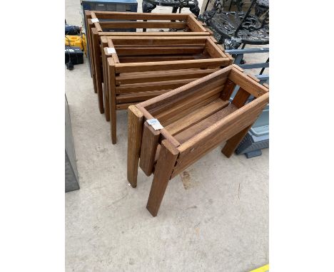 A SET OF THREE WOODEN TROUGH PLANTER HOLDERS 