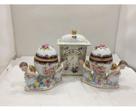 A PAIR OF RENAISSANCE STYLE ORNATE TRINKET BOXES WITH CHERUBS PLUS A FLORAL CERAMIC MANTLE CLOCK 