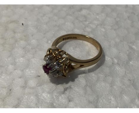 A 9CT GOLD RING WITH RUBY AND CUBIC ZIRCONIA STONES 