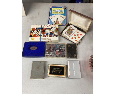 A QUANTITY OF PACKS OF VINTAGE PLAYING CARDS PLUS A CARD GAMES AND TRICKS BOOK 