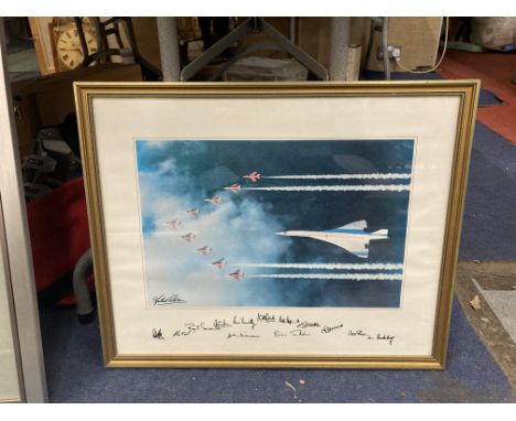A FRAMED PRINT OF CONCORDE FLYING WITH THE RED ARROWS WITH SIGNATURES TO THE BOTTOM 54CM X 43.5CM 