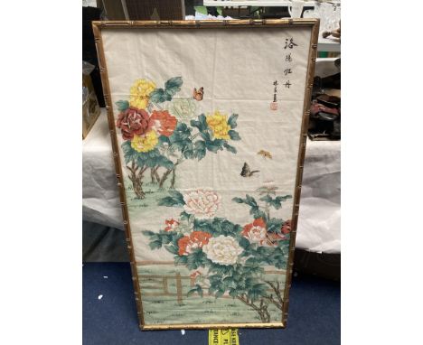 AN ORIENTAL PRINT ON SILK OIN A BAMBOO FRAME 109CM X 58.5CM 
