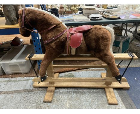 A VINTAGE ROCKING HORSE ON A WOODEN ROCKING BASE WITH RED SADDLE HEIGHT TO SADDLE APPROX 75CM 