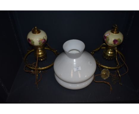 Two retro ceiling light in the form of gas lamps having floral ceramic detail and white shades.