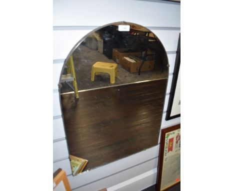 A vintage wood backed wall mirror.