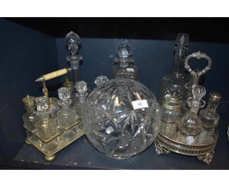 A mixed lot of vintage glass including decanters, condiment sets and more.