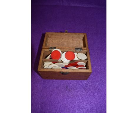 A small box of vintage tiddly winks.
