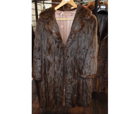A vintage mid length brown fur coat.