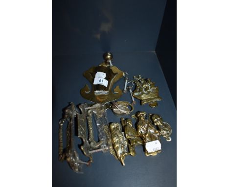 A collection of vintage brass door knockers and handles.