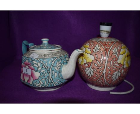A Charlotte Rhead for Bursley ware tea pot having blue and white ground with pink chrysanthemum like design to front and rear