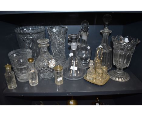 A good quantity of vintage glass ware including decanters, condiment sets and vases.